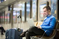 Business-traveler-waiting-on-laptop